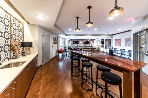 A kitchen with a bar area and a dining table.