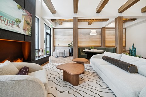 A modern living room with a fireplace and a large painting on the wall.