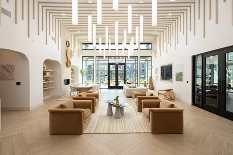 a living room with couches and chairs and a rug