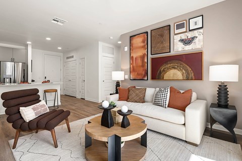 A modern living room with a brown chair and a white couch.