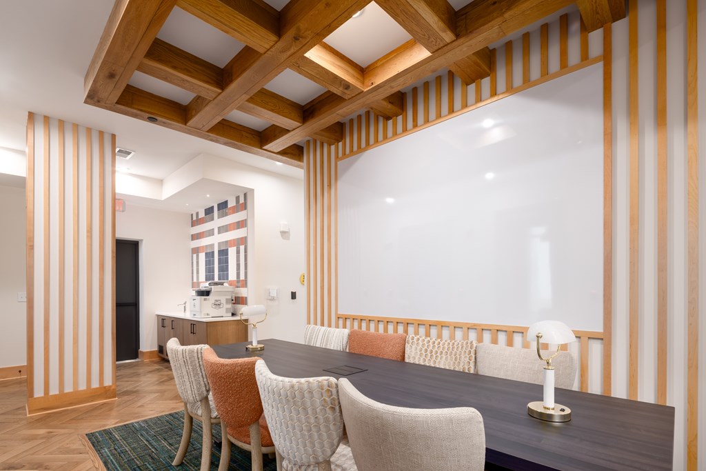 A dining room with a wooden table and chairs.
