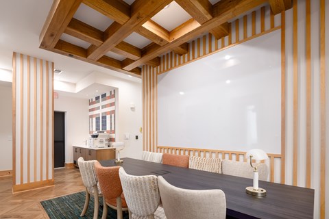 A dining room with a wooden table and chairs.