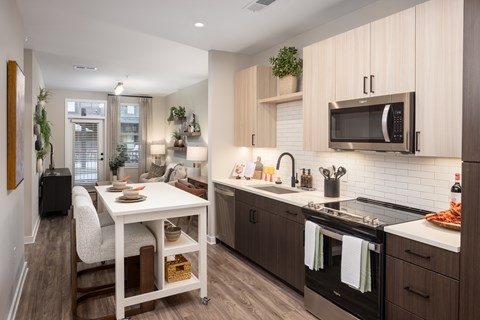 A modern kitchen with a dining table and chairs.