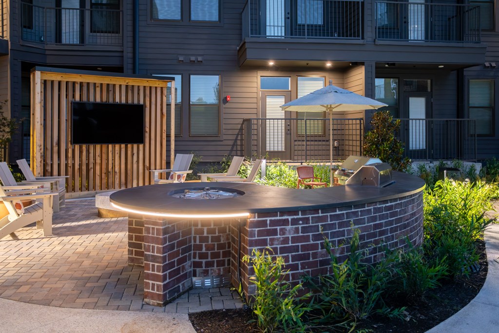 Outdoor grilling area with TV and fire table