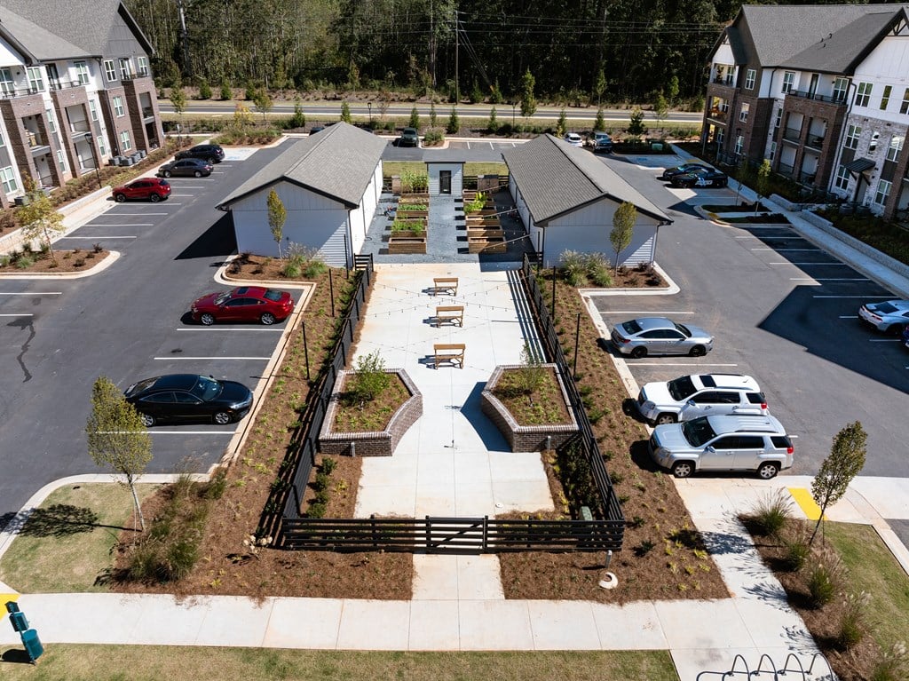 an aerial view of a yard with cars parked in a parking lot