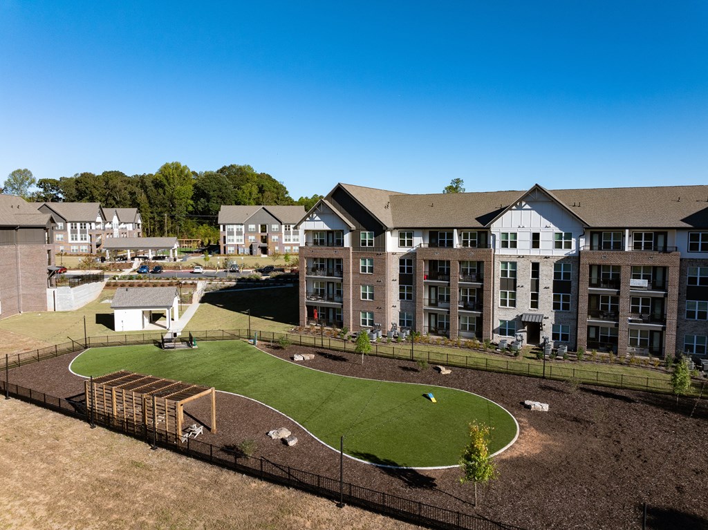 an aerial view of an apartment complex with a park and a playground