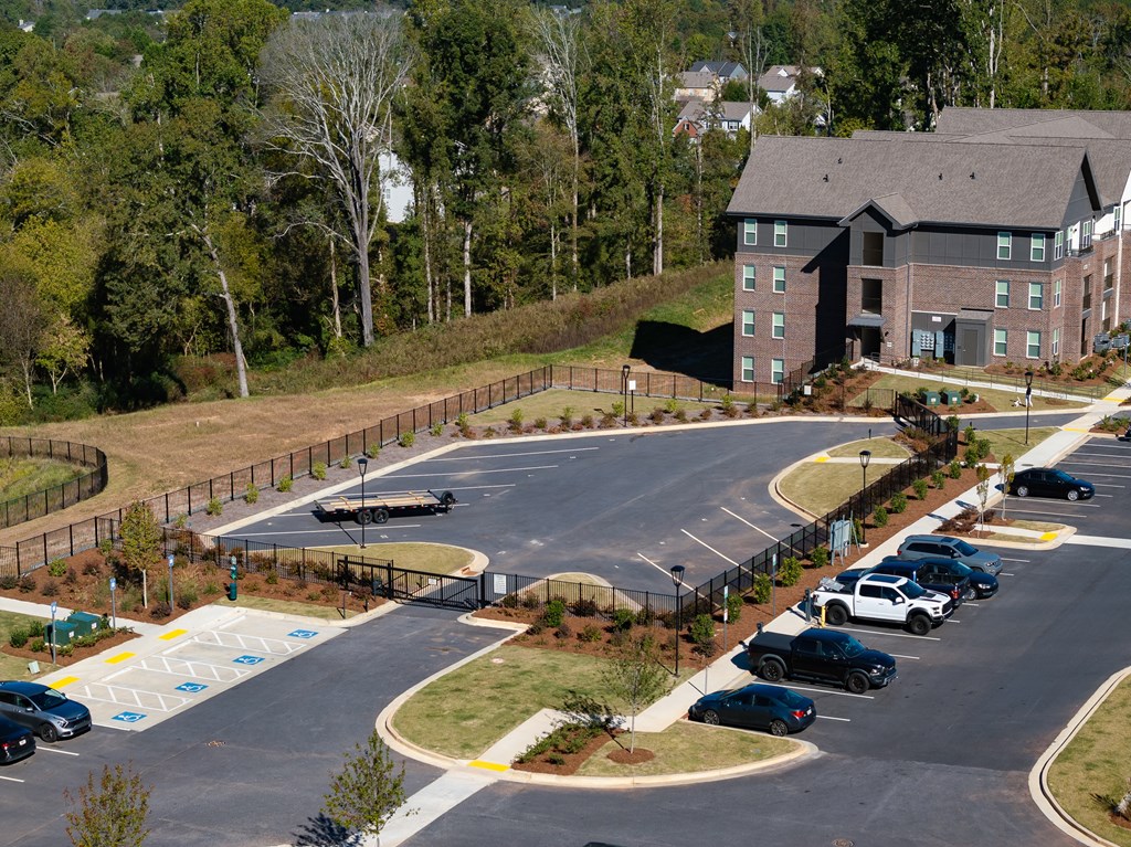 a parking lot with cars in front of a building