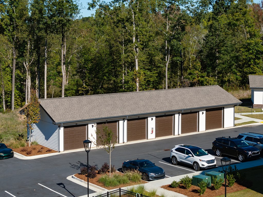 an aerial view of a building with cars parked in a parking lot