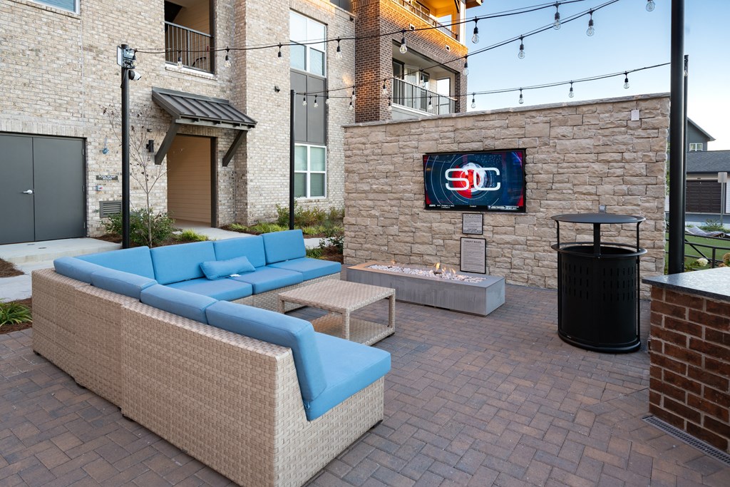a living room with couches and a fire pit