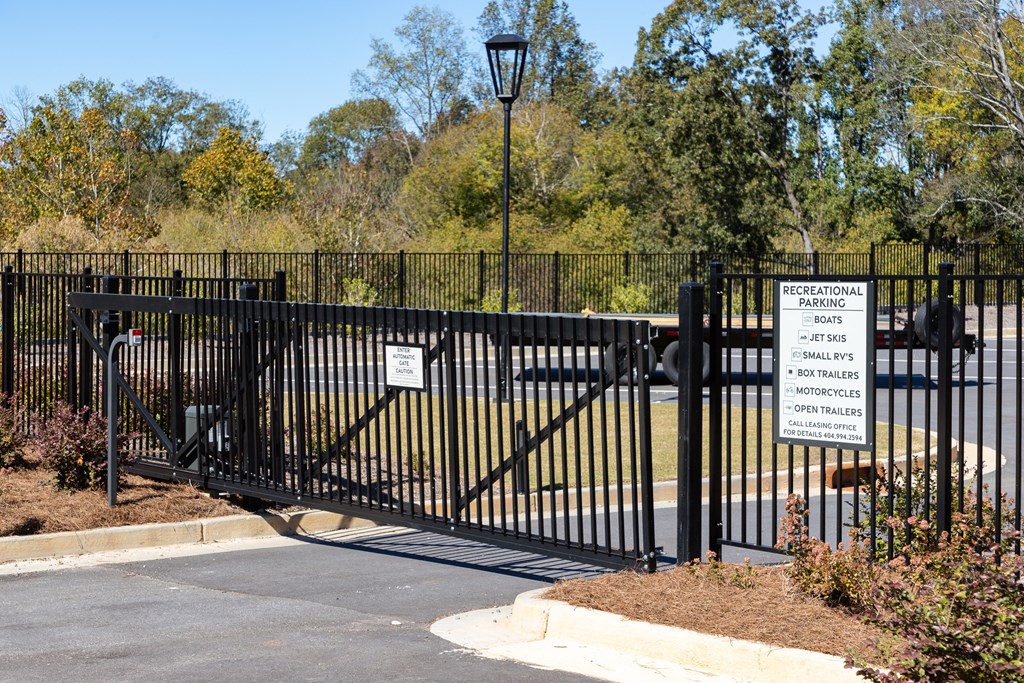 a black wrought iron gate with a sign in front of a park