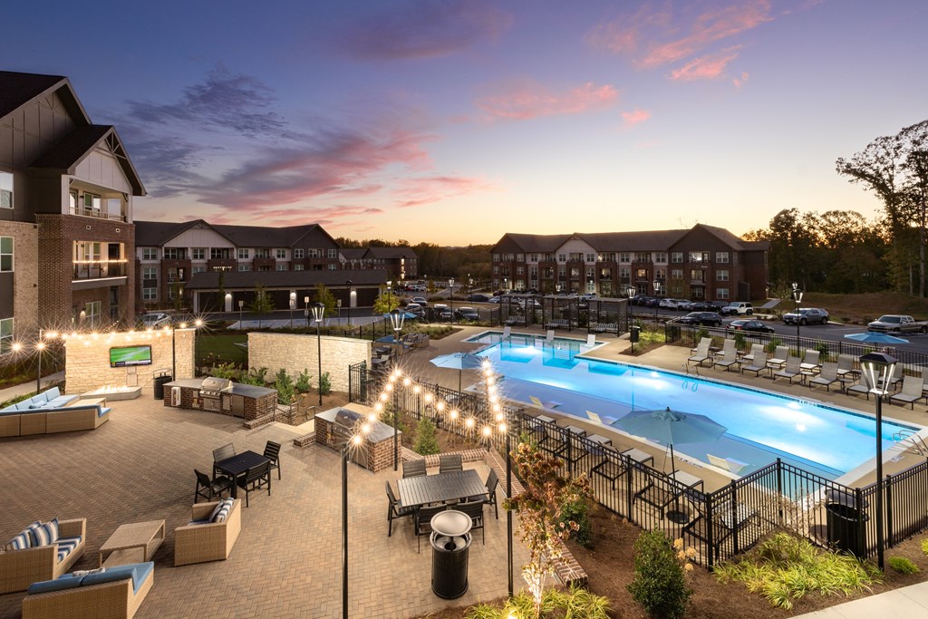 an aerial view of a resort pool at dusk