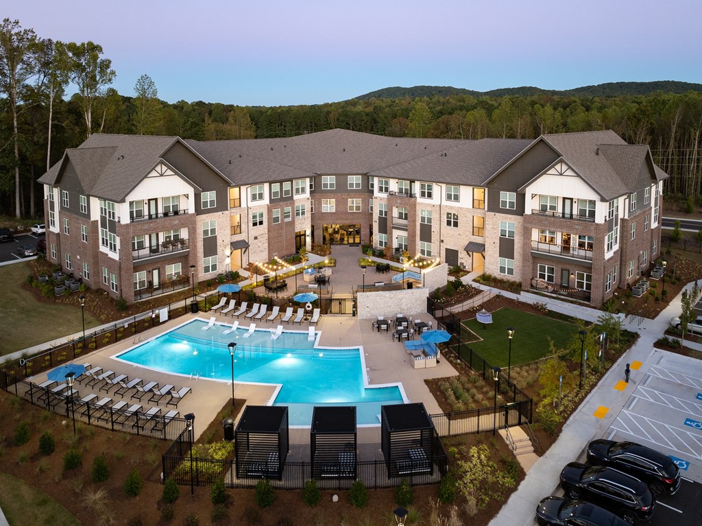 an aerial view of an apartment building and an outdoor pool