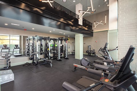 A gym with treadmills, weights and other exercise equipment.