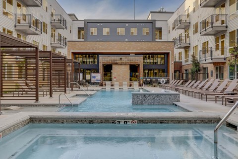 A large indoor swimming pool with a waterfall feature in the middle.