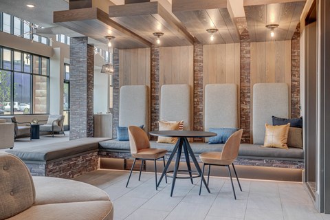 A modern dining area with a wooden table and chairs.