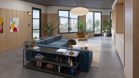 A modern living room with a blue sofa and a glass coffee table.