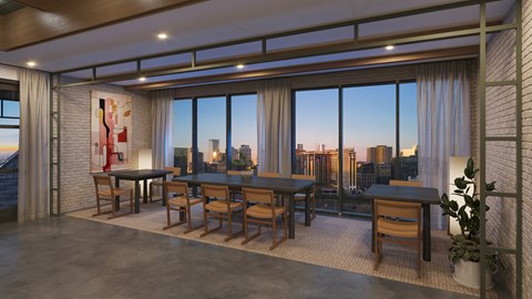 A dining room with a view of the city at dusk.