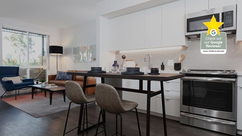 A modern kitchen with white cabinets and a large island with chairs around it.