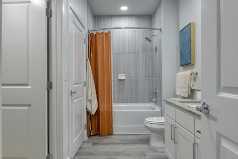 A bathroom with a toilet, sink, and shower.
