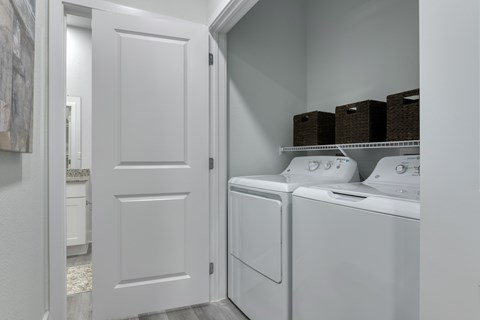 A white laundry room with a washer and dryer.