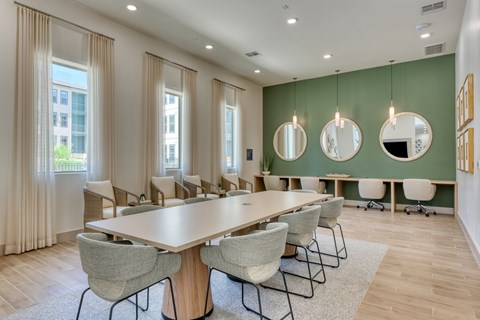 A conference room with a long table and chairs.