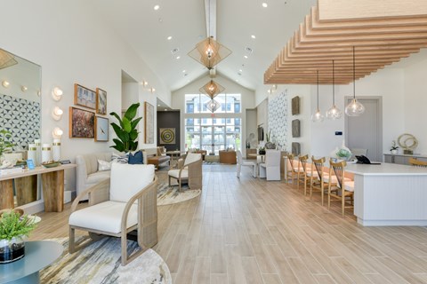 A spacious living room with a white sofa and wooden flooring.
