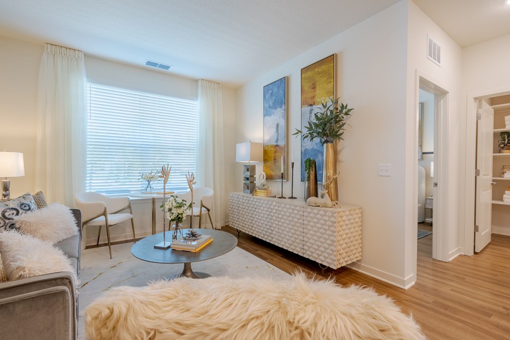 A living room with a white sofa and a grey coffee table.