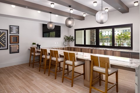 A dining room with a long table and chairs.