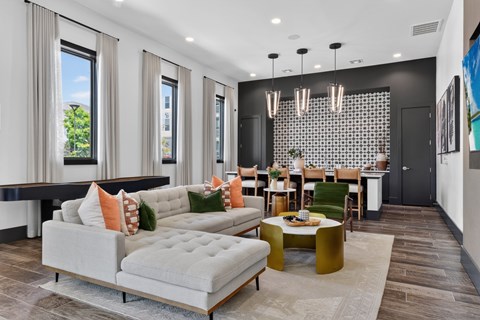 A modern living room with a grey sofa and a coffee table.