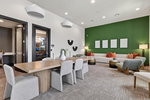 A modern dining room with a wooden table and grey chairs.