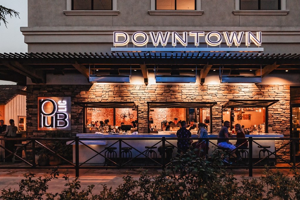 a group of people outside of a downtown restaurant