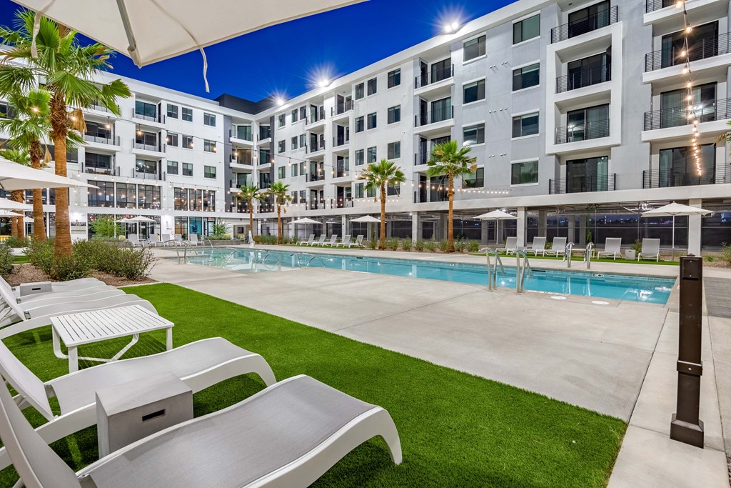 a swimming pool with a building in the background
