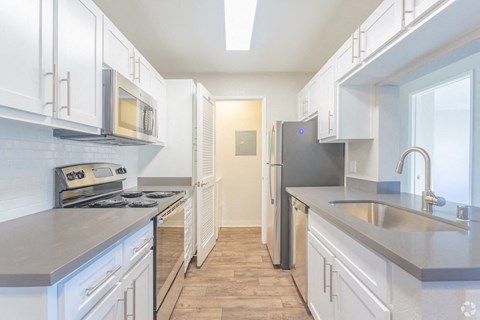 Morgan Hill CA Apartments for Rent - Monte Vista - Kitchen with White Cabinetry, Silver Appliances, and Grey Countertops renovated kitchen space
