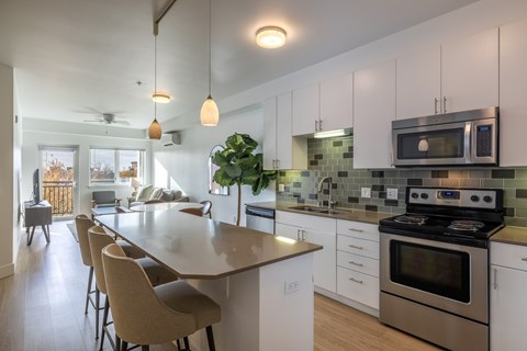 A kitchen with a large island and a stove top oven.
