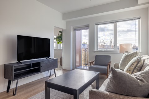 A living room with a television and a chair.