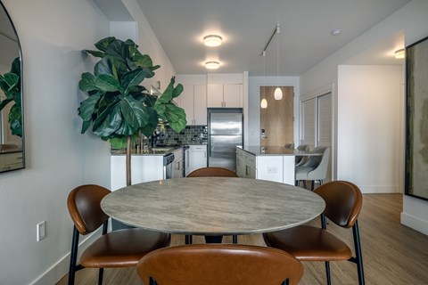 A modern dining room with a large table and chairs.