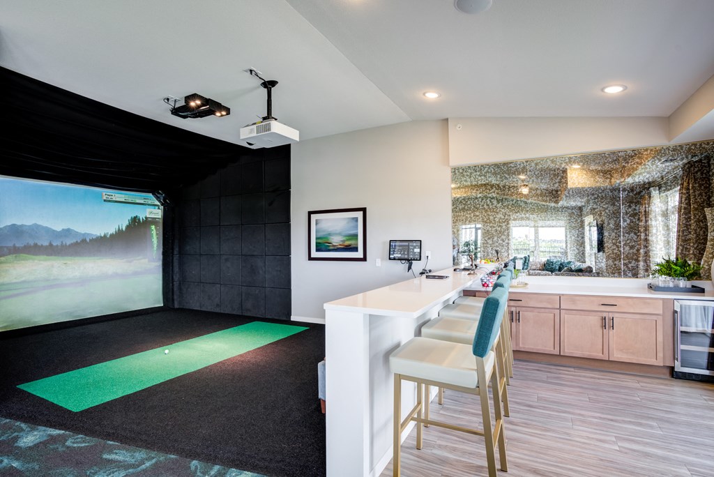 a kitchen with a bar and a painting on the wall