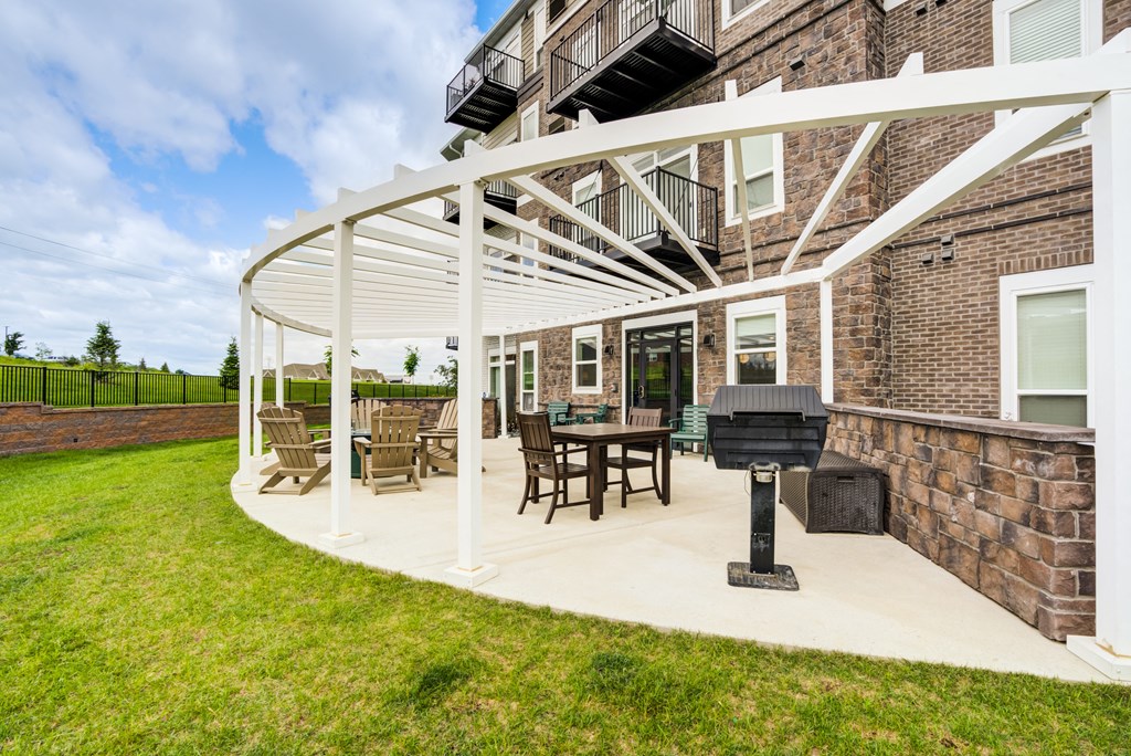 the preserve at ballantyne commons clubhouse with patio furniture and a grill