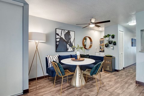 A dining room with a round table and chairs.
