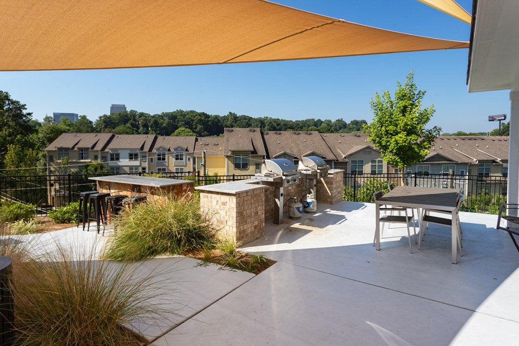 A sunny day at a residential area with houses and a patio.