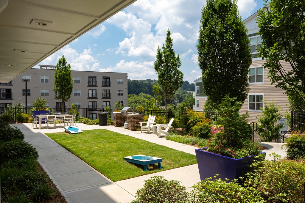 A sunny day at a residential complex with a pool and a playground.