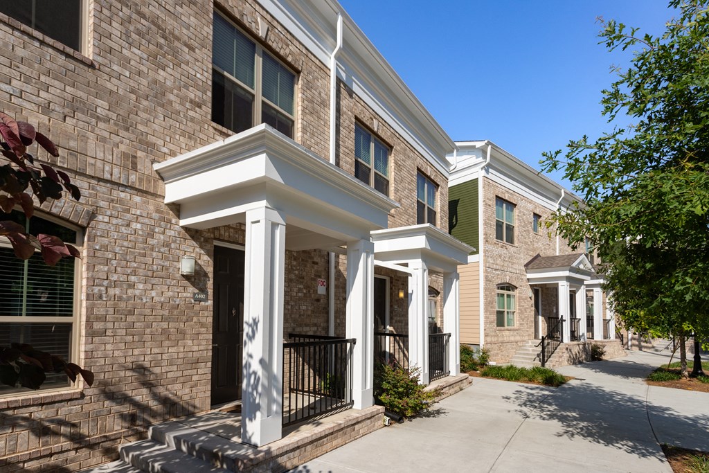 A row of houses with white columns in front.