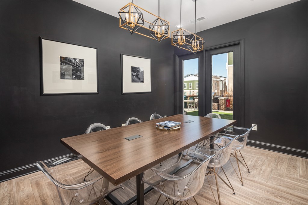 A dining room with a wooden table and chairs.