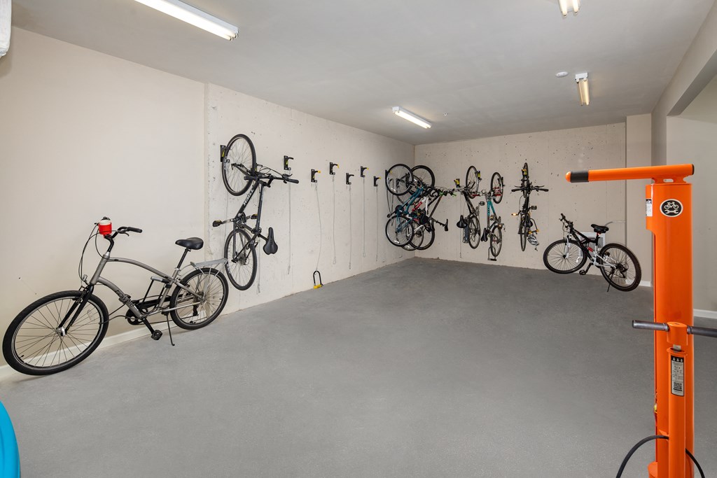 A bike shop with a white wall and a bike rack.