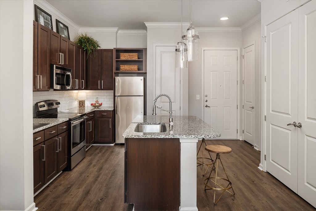 A kitchen with brown cabinets and a white counter.