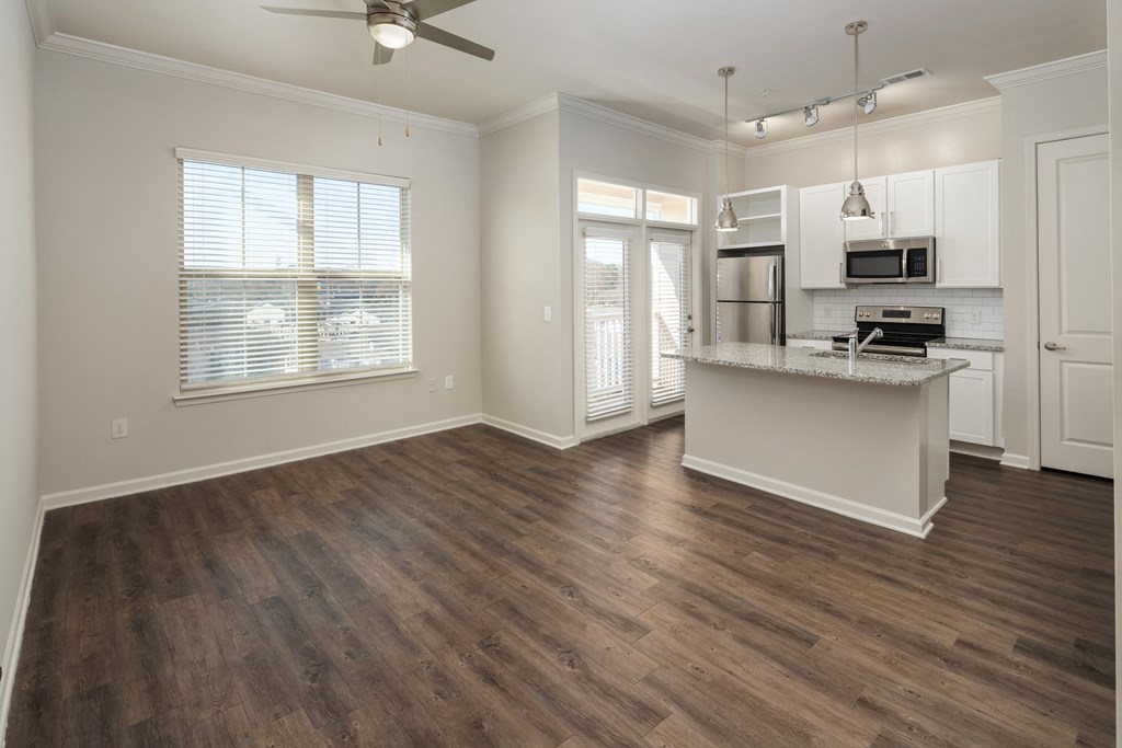 A kitchen with a countertop and a fan.