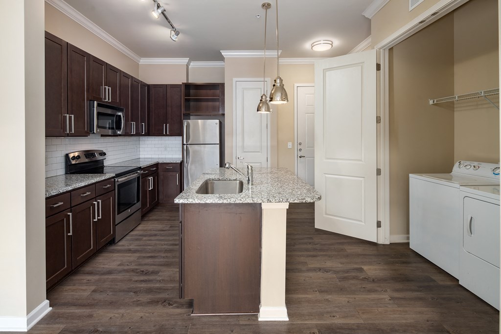 A kitchen with brown cabinets and a white island.