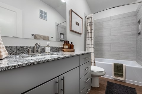 A bathroom with a toilet, sink, and bathtub.