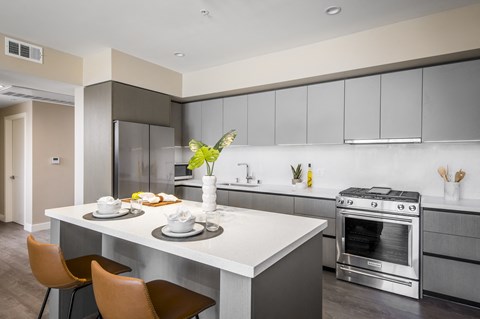 a kitchen with a white table and chairs and a stove