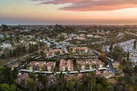 A residential area with houses surrounded by trees.